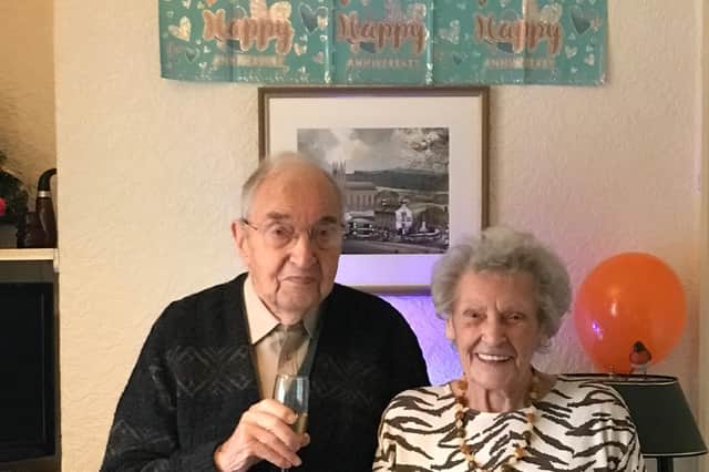 Norman and Gladys Bell are celebrating their 75th wedding anniversary. The picture behind them is of the church where they were married in Uppermill, Saddleworth.