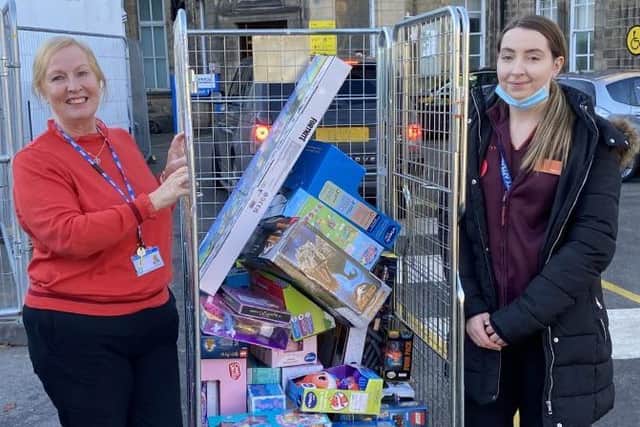 Bay Hospitals Charity manager Judith Read accepting a donation of gifts from Lucy Foxcroft from the Lancaster branch of Sainsbury's.