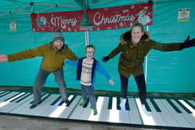 Playing the 'Big' piano at the Team Reece Winter Wonderland are Paul and Christine Gardner with son Joseph.