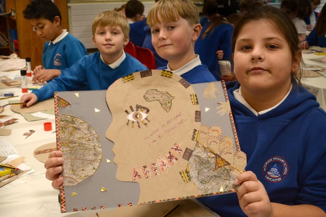 Students from Moorside Elementary School with some of their Facing The Past artwork.  Photo by Darren Andrews.