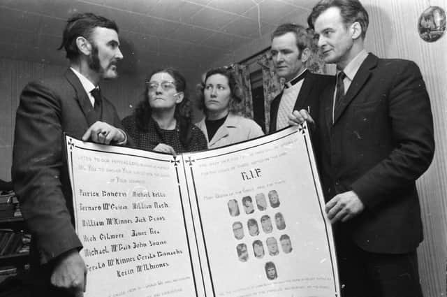 A Mass card made by the Derry internees at Long Kesh is presented on their behalf by Mr. Frank Gogarty (right), former chairman of the NI Civil Rights Association, to Mr. and Mrs. J. Wray, Drumcliffe Avenue, parents of James Wray, one of the Bloody Sunday victims in 1972.
