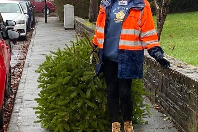 A volunteer with a tree for recycling.