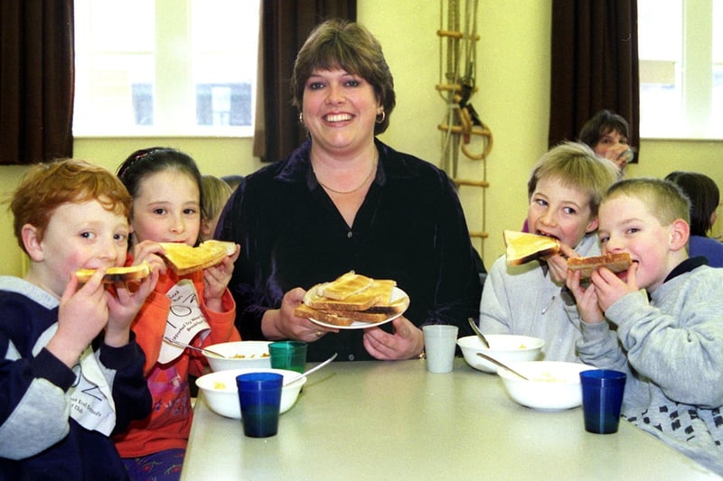 Sue Fielden, head teacher of West End Primary School in Morecambe, delivers toast to Cameron Thomson, Kirsty Thomson, Rory Knowles and Adam Larn as the school launches a Breakfast Club in 2000.