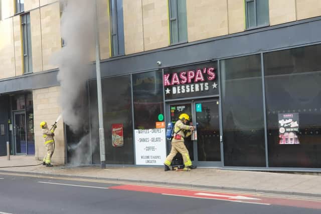 Smoke can be seen pouring from a broken window after a fire broke out at Kaspa's Dessert Parlour in Lancaster. Picture by Graham Dalton.