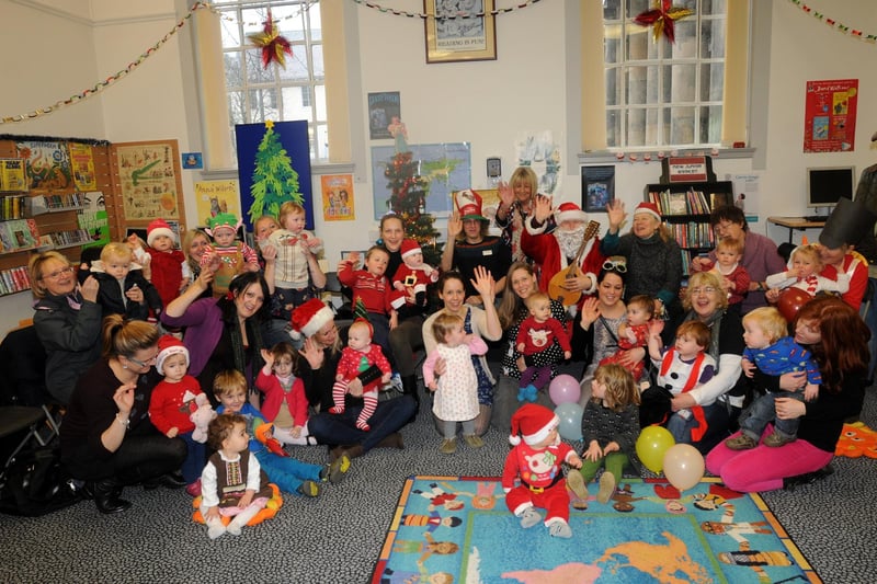 Father Christmas with members of the Baby Bounce and Rhyme Group in Lancaster Library with musician Chris Price and organiser Linda Percival.