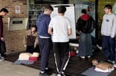 Medical students Ella Spry (left) and Tivon Dillner (right) teaching resuscitation techniques on campus.