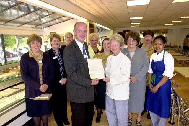 David Roddam, Principal of Lancaster and Morecambe College, presents Customer Care Certificates to college catering staff.