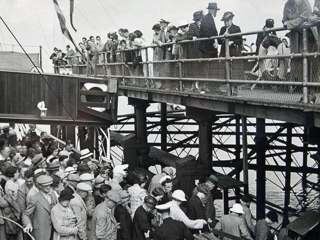Crowds queue for boat trips to and from Morecambe's Central Pier.