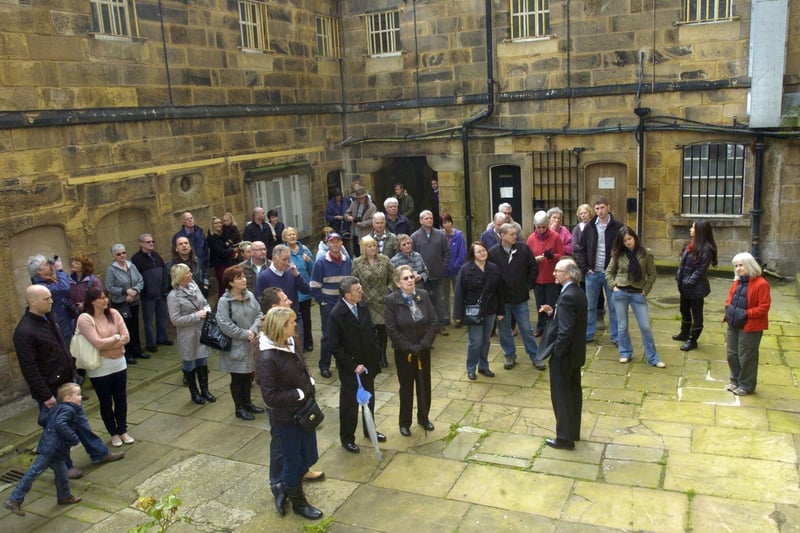 Manager of the Shire Hall and Lancaster Castle, Colin Penney, with the first group of the public taken on a guided tour of the prison. They are pictured in the chapel yard.