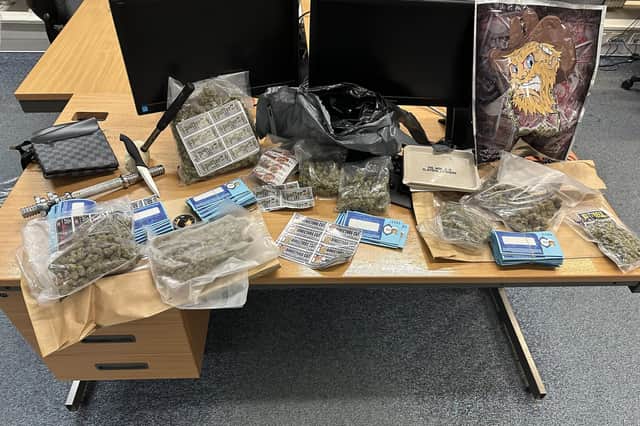 SOme of the drugs and weapons found in the car.