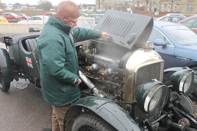Checking under the bonnet of one of the cars on display at the Midland at the weekend.