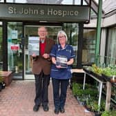Wray historian David Kenyon with nurse Sarah Gorst at St John's Hospice. David and Sarah are pictured with the front covers of the local history book David has written, the proceeds of which are being donated to the hospice.