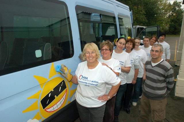 Staff from Axa Insurance with site supervisor Tom Marsh who spent a day cleaning up Morecambe Road School, painting and washing mini buses as part of the community challenge event, Hearts In Action 2010.