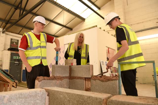 Carly lost her arm in a car accident and supports 'challenging' young adults to go into construction apprenticeships