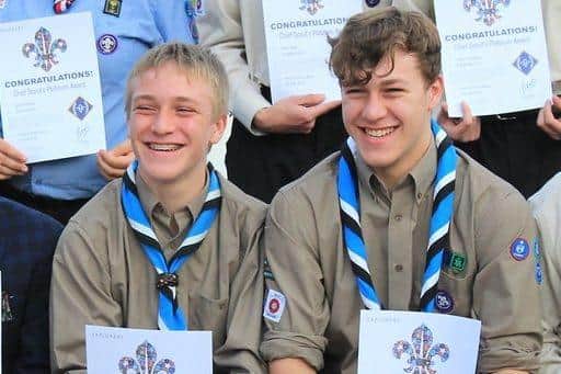 Lucas (left) with his brother Isaac collecting the Chief Scout Platinum Award.
