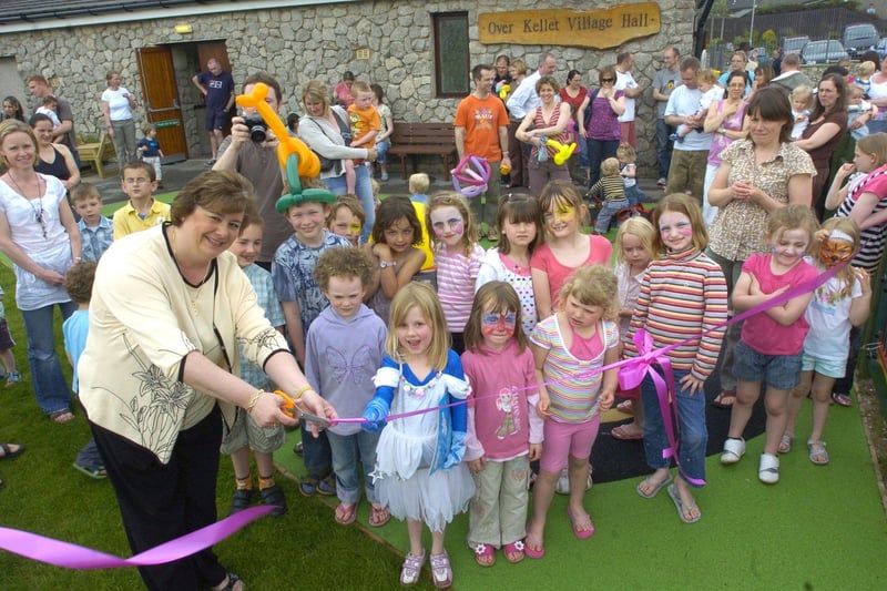 Headmistress at Over Kellet School Jo Williams cuts a ribbon to open the playgroup's new play area.