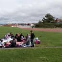 The group enjoying their lunch-time picnic in Morecambe.