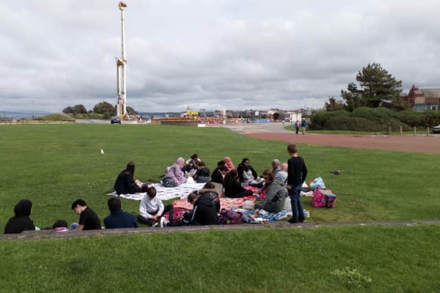 The group enjoying their lunch-time picnic in Morecambe.