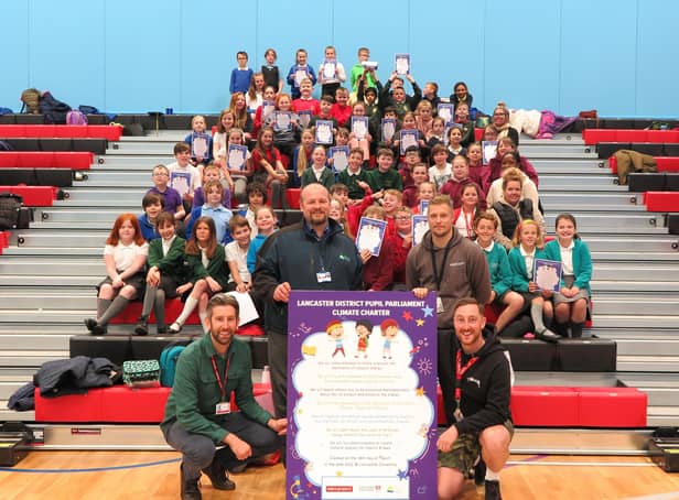 Charles Sainsbury from the Eden Project, Lancaster & Morecambe College Principal Wes Johnson and Mark Gardner and Nik Marsdin from Lancaster University, with Pupil Parliament representatives and the Lancaster District Pupil Parliament Climate Charter.
