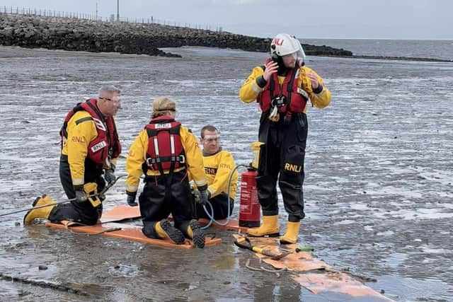 RNLI volunteers demonstrated a simulated mud rescue.