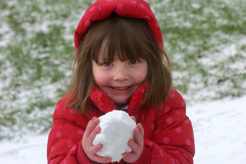 Ceira Sanderson, three, making snowballs in Ryelands Park.