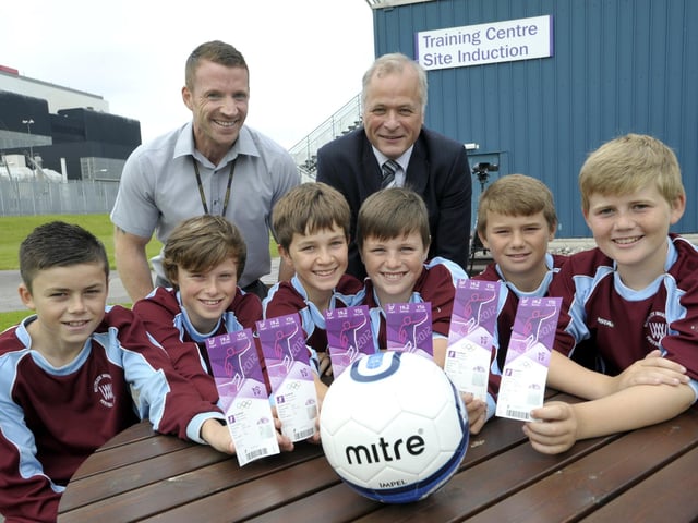 Heysham 2 Power Station director Alan Oulton (right) and Andy Lockley of Heysham 2 with Westgate Wanderers under 13s team members and their tickets to see the final stages of Olympic football at Old Trafford in 2012. EDF Energy was an official partner of the London 2012 Olympic and Paralympic Games and provided 70 tickets for Trumacar, St Peter's, Mossgate, St Patrick's and Westgate Primary Schools, and Westgate Wanderers.