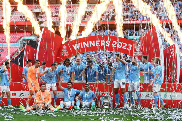 Players of Manchester City celebrate alongside the FA Cup Trophy after victory during the Emirates FA Cup Final between Manchester City and Manchester United at Wembley Stadium on June 03, 2023 in London, England. Five men have been sentenced for illegally streaming Premier League matches. (Photo by Mike Hewitt/Getty Images).