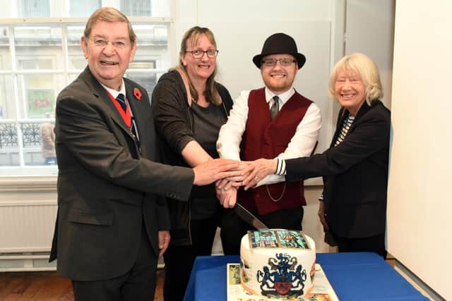 The mayor Coun Roger Dennison cuts the centenary cake with cake designer, Cate Gardner, FOLCM chair Christopher Tinmouth and Coun Sandra Thornberry. Picture by Steve Pendrill Photography