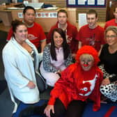 Staff from AXA Insurance who raised money for Comic Relief on Red Nose Day with a dress down day, raffle and the sale of cakes made by staff and 13-year-old Rosie Melrose.