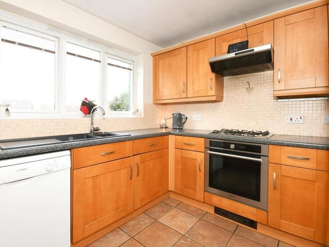 The kitchen/diner from a second angle. It features a range of appliances, plus storage space and work surfaces.