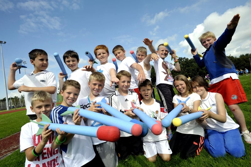 Children with their 'javelins' at a Lancaster City Council play scheme mini olympics at Salt Ayre track.
