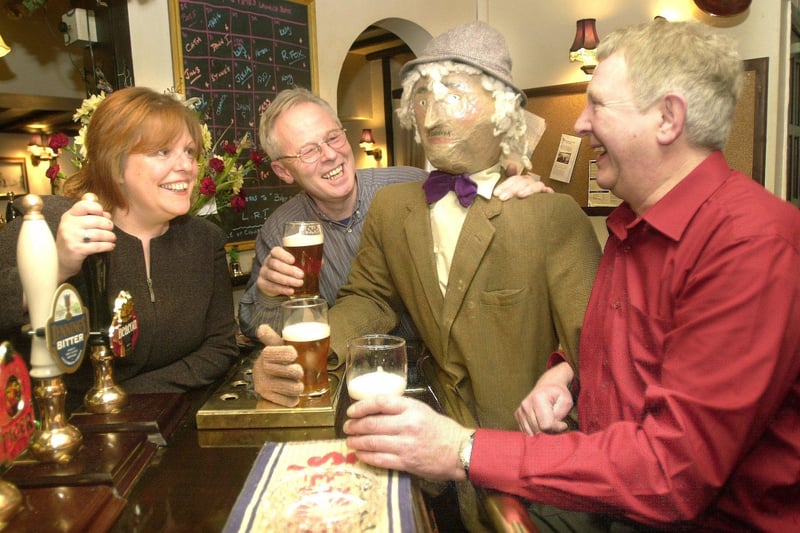 Landlady of the George and Dragon at Wray, Jo Baker, shares a joke with regulars John Millington (rear), David Hartnup and 'Ray' the scarecrow in 2002, who had called in to publicise the Lancashire Tourism Guide and Wray Scarecrow festival.
