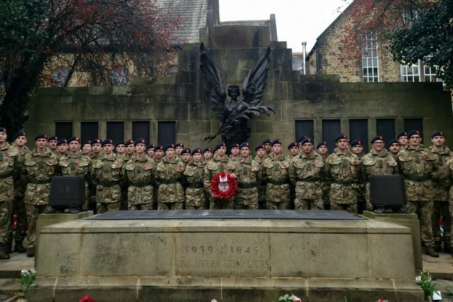 Soldiers lined up with a poppy wreath at the war memorial in Lancaster.