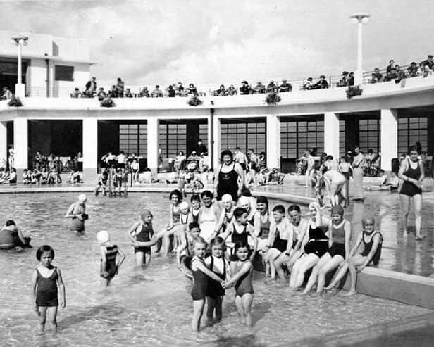 Swimmers of all ages pose for a picture at the old swimming stadium in Morecambe.