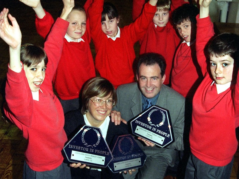 Staff development co-ordinator, Sue Goodwin and pupils at Sandylands School, Morecambe, celebrate the school winning a LAWTEC Investor in People award, presented by the investor in people manager, Tim Callaghan.