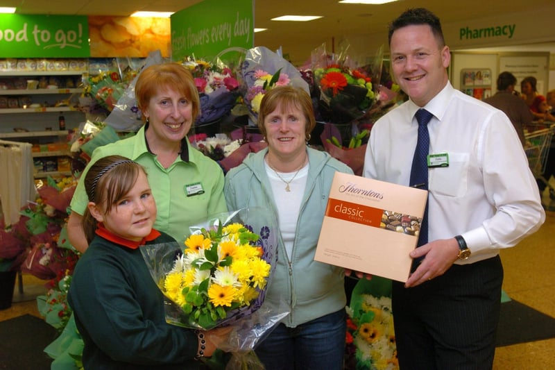 Asda store manager Colin Thwaytes and events co-ordinator Jo Wilcock present Jackie Walsh with flowers and chocolates when she won the local Wondermum competition after being nominated by her 10-year-old daughter Lauren.