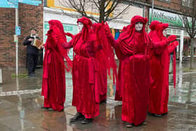 Extinction Rebellion protestors dressed head to foot in red were in Morecambe this weekend to highlight the 'shocking state' of our waterways.
