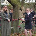 Art teacher Emma Field with some of the pupils who took part in making the poppy display.