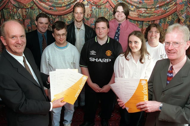 Principal of Lancaster and Morecambe College David Roddam (left) and Brian Shannan (right) from Employment Services present students from the college with their 'New Deal' certificates in 1999