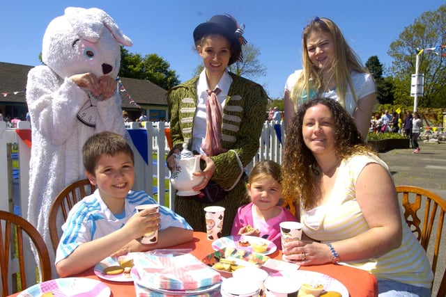 Sharon, Sean and Chloe Potts enjoy a Mad Hatter's tea party with Alice and the Mad Hatter at a Teddy Bears' Picnic event in Happy Mount Park in May 2013.