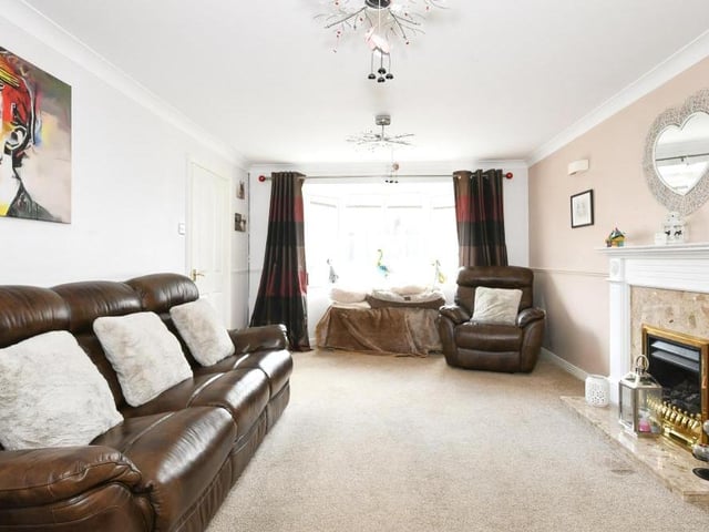 A spacious entrance hall takes you in to this living room or lounge, which has real size about it. With its bay window front and feature fireplace, the room is full of style and comfort too.