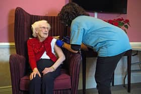 One hundred year-old Ellen Prosser, known as Nell, receives the Oxford/AstraZeneca Covid-19 vaccine from Dr Nikki Kanani at the Sunrise Care Home in Sidcup, south east London on January 7, 2021. (Photo by Kirsty O'Connor / POOL / AFP) (Photo by KIRSTY O'CONNOR/POOL/AFP via Getty Images)