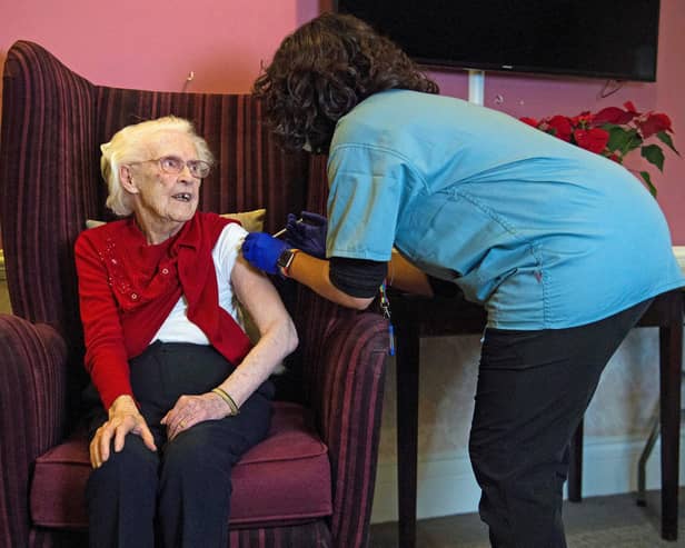 One hundred year-old Ellen Prosser, known as Nell, receives the Oxford/AstraZeneca Covid-19 vaccine from Dr Nikki Kanani at the Sunrise Care Home in Sidcup, south east London on January 7, 2021. (Photo by Kirsty O'Connor / POOL / AFP) (Photo by KIRSTY O'CONNOR/POOL/AFP via Getty Images)