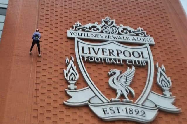 Clare Lyden abseiling down the famous frontage of Anfield stadium.