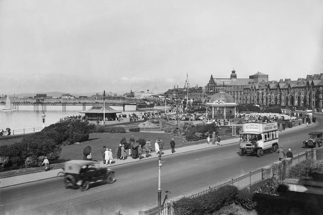 Morecambe West End seafront from the south, with cars and a bus in the foreground in 1925-30.