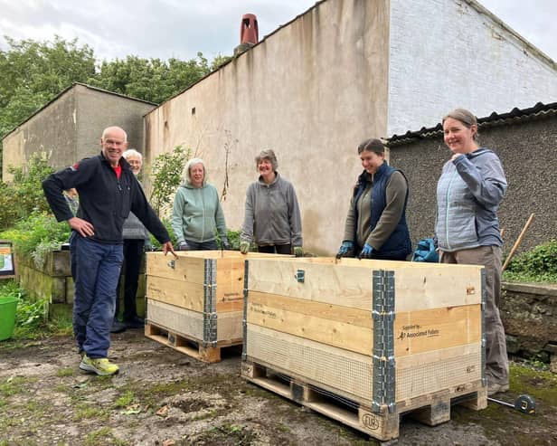 Community members with the newly built rat-proof compost bins during the launch in September 2023
