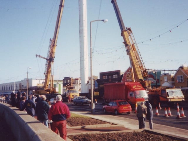 Members of the public watch as the Polo Tower arrives at Frontierland in Morecambe.