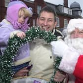 Santa is on hand to give out sweets to Carl York and Alice, two at the Lytham Christmas lights switch-on in 2002