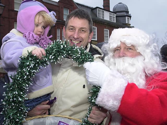 Santa is on hand to give out sweets to Carl York and Alice, two at the Lytham Christmas lights switch-on in 2002