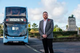 Stagecoach MD Tom Waterhouse at the cenotaph in Morecambe with the Poppy Bus. Photo: Sheenah Alcock